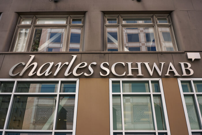 The Charles Schwab logo is seen at a location of the American bank and stock brokerage firm in the SoMa District of San Francisco - robo-adviser, sec