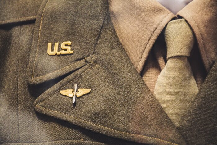 Gold-colored U.S. Brooch on military uniform.