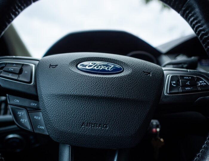 Close up of Ford emblem on a steering wheel - ford class action