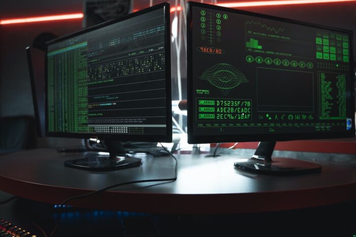 Close up of two computer monitors displaying a hacking software on the screens - data breach, ransom