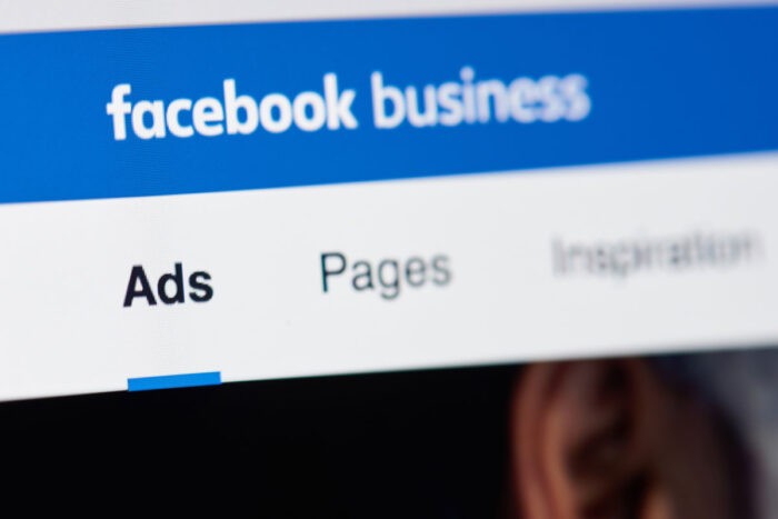 Facebook business page for advertising on laptop screen close-up - Facebook settlement, housing ads