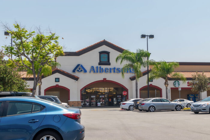 Exterior of an Albertsons store against a clear blue sky.