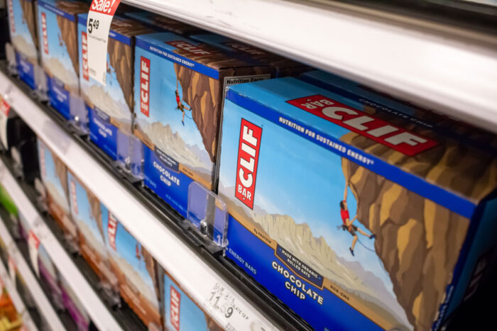 A view of several Clif Bar products on a shelf at a grocery store.