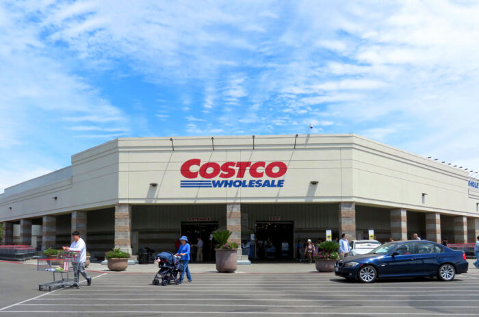 Exterior of a Costco wholesale store against a blue sky - Costco recall, solar umbrella