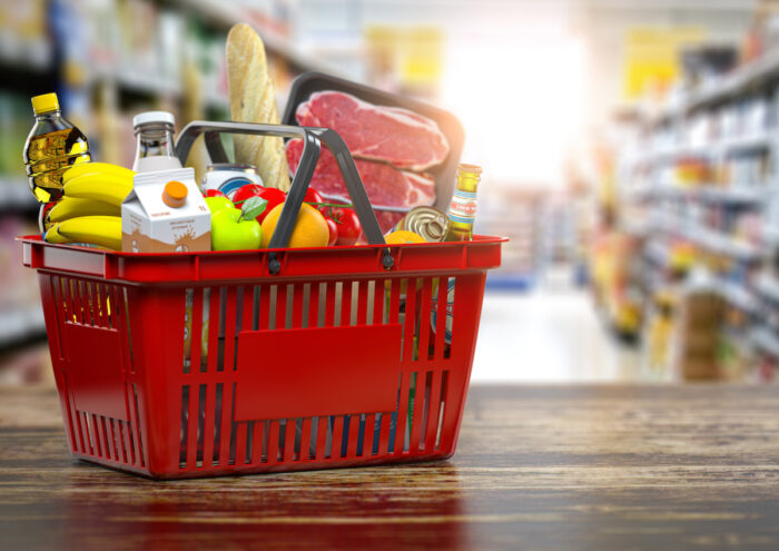 Close up of a grocer store or supermarket basket containing fresh food.