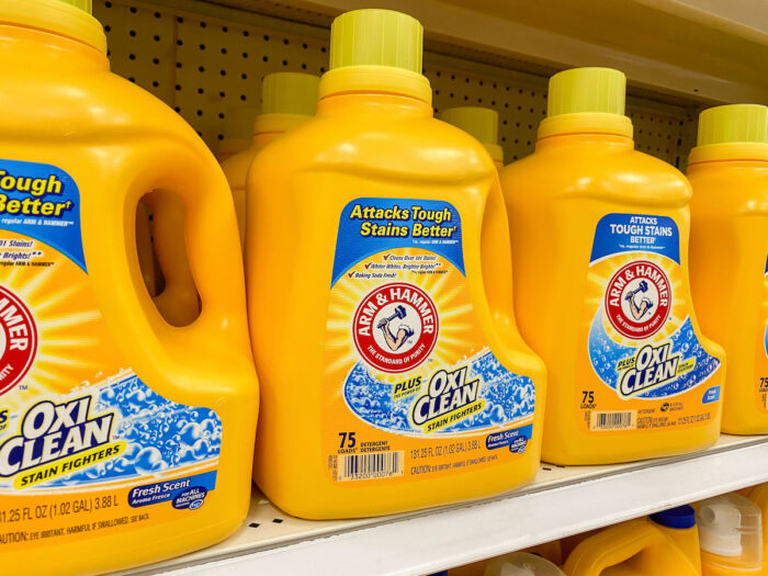 Bottles of Arm and Hammer Laundry Detergent on a store shelf.