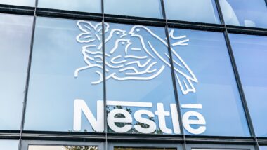Close up of Nestle logo on an exterior glass building.