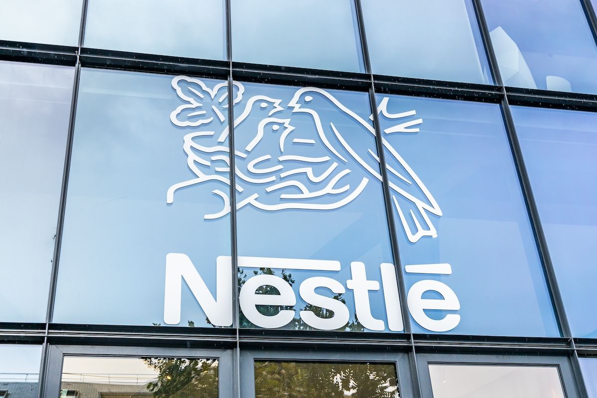 Close up of Nestle logo on an exterior glass building.