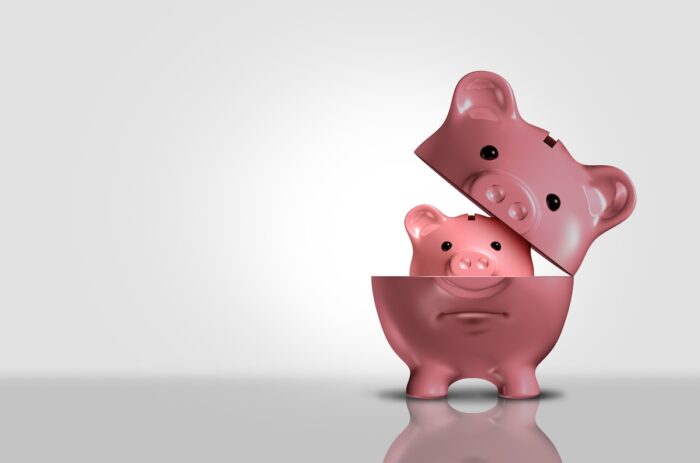 A 3D render of a piggy bank getting smaller. Shrinkflation concept.
