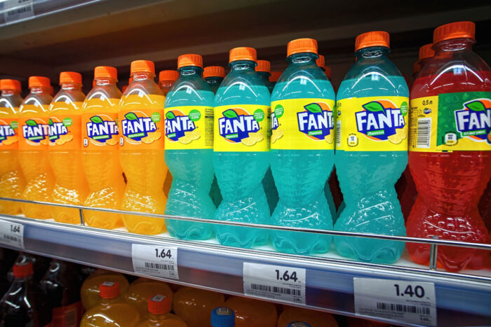 Fanta in plastic bottles display on shelf for sale in supermarket - Coca-Cola class action