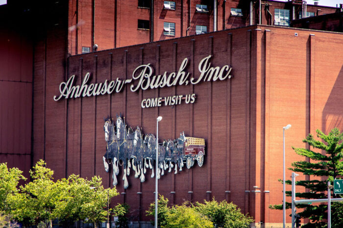 Close up of Anheuser-Busch signage on exterior of a brick building.