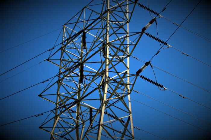 An electrical tower against a blue sky - First Energy settlement, ohio edison lawsuit