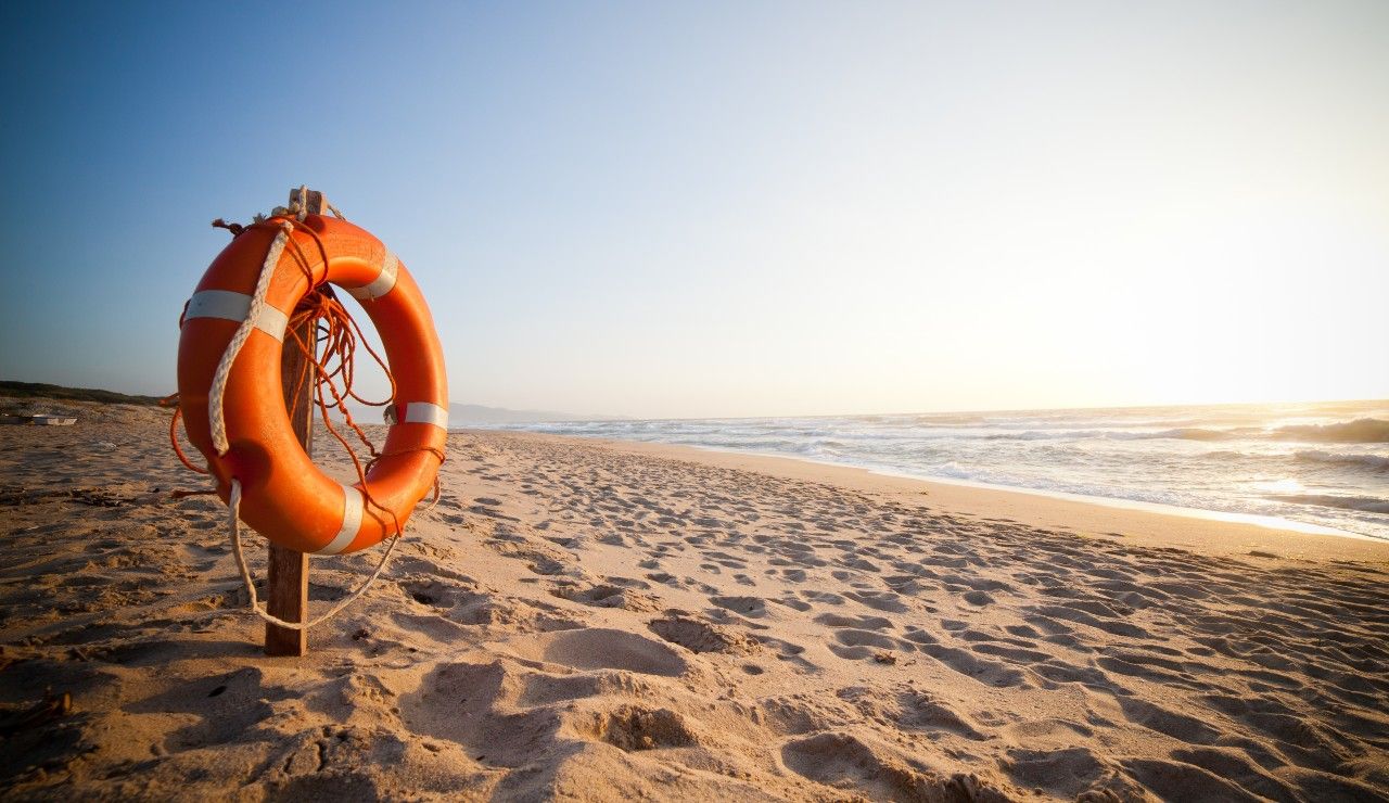 Life Buoy on beach post at sunset