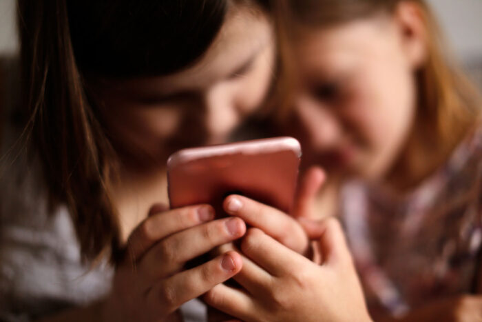 Close up of girls using a smartphone.