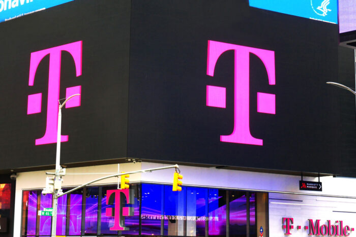 T-Mobile logo on a big screen - settlement, data breach