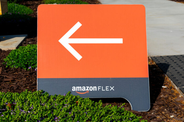 Amazon Flex sign directs independent contractors to delivery services at Amazon Flex Distribution Center.