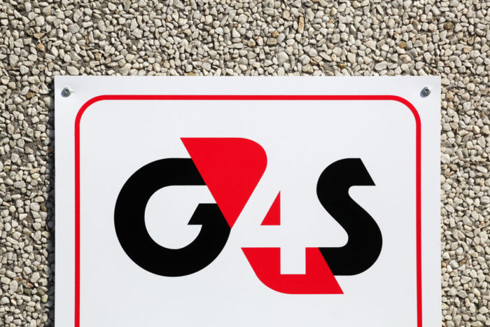 G4S logo on a wall - G4S Secure Solutions settlement, g4s class action, fcra lawsuit