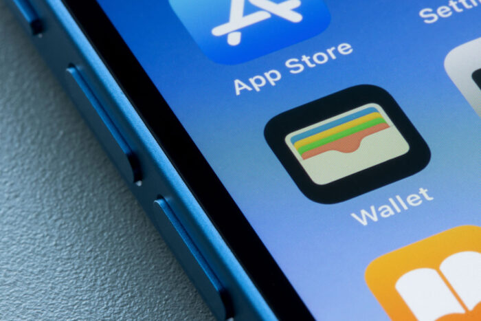 Close up of Apple Wallet app icon is seen on an iPhone - class action