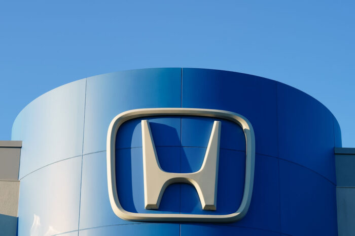 Close up of Honda signage against a blue sky.