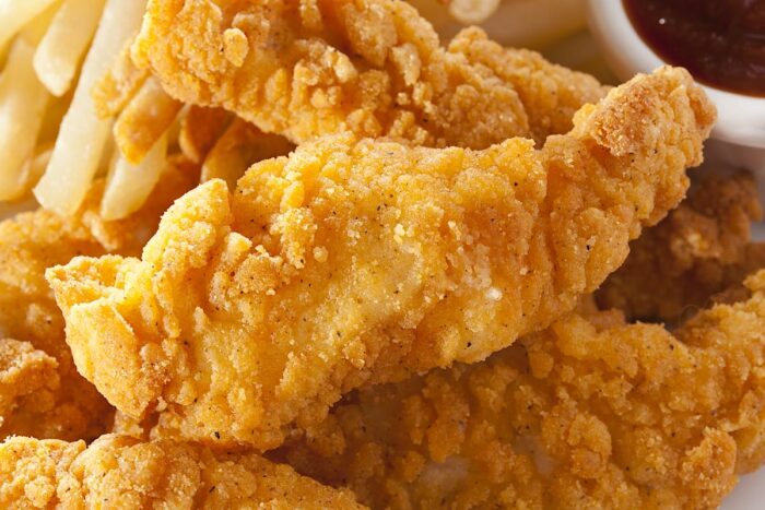 Close up of chicken tenders on a plate.