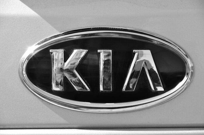 Close up of old Kia emblem on a vehicle.
