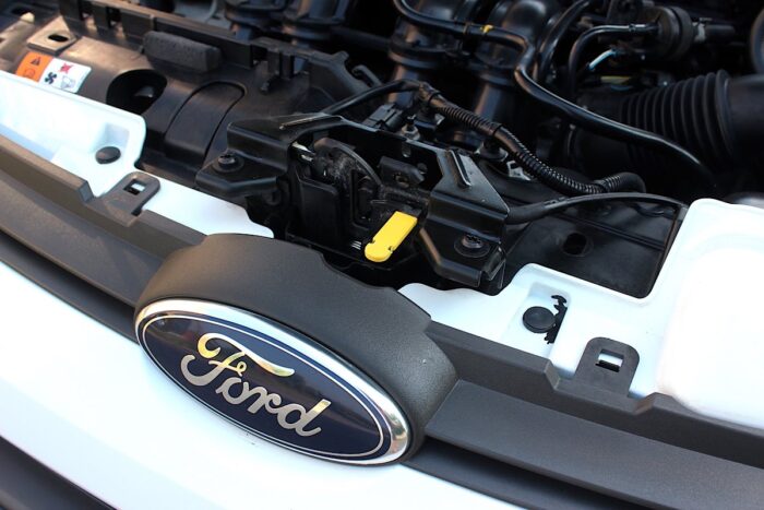 Ford Fiesta hood opening key. Ford Fiesta logo and emblem. Ford Fiesta part of engine.