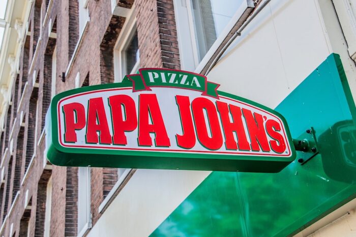 Close up of Papa Johns signage on exterior of building.