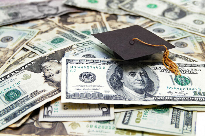 Mini graduation cap on US money.