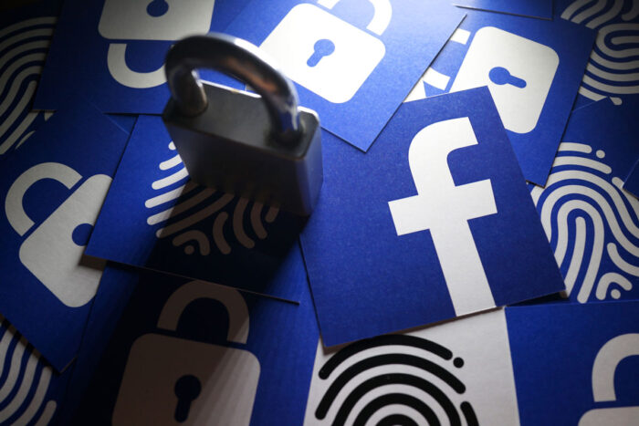 Close up Facebook logo with the security lock and thumb print icons surrounding it.