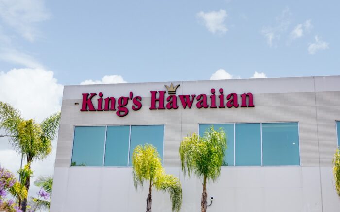A building front sign for the King's Hawaiian headquarters - King's Hawaiian pretzel
