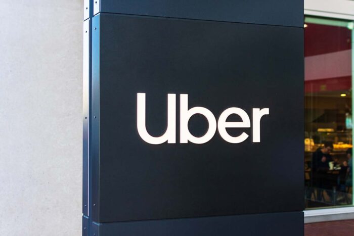 Uber sign and logo near the entrance to headquarters of Uber Technologies.