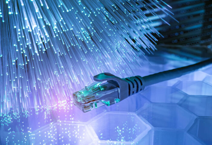 Network cables with fiber optical technology background. Broadband internet concept.