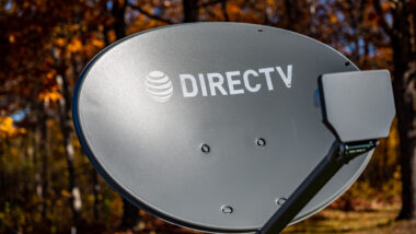 Directv satelite dish with fall leaves in the background.