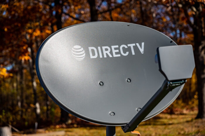 Directv satelite dish with fall leaves in the background.