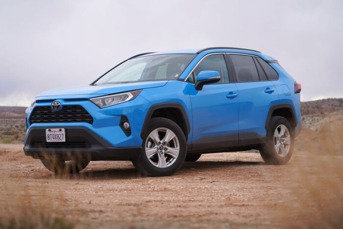 Blue Toyota RAV4 parked on a dirt road in the Utah wilderness with overcast sky - adaptive headlights