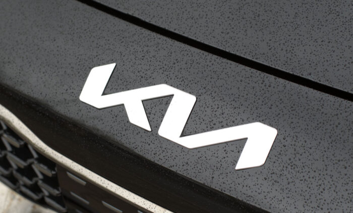 KIA Motors new angular logo on black hood of Kia with water drops - auto theft