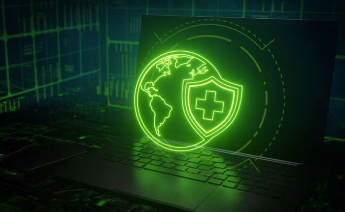 Close up of a globe and healthcare shield graphic in front of a laptop. Healthcare data breach concept - Humana class action lawsuit, Cotiviti settlement