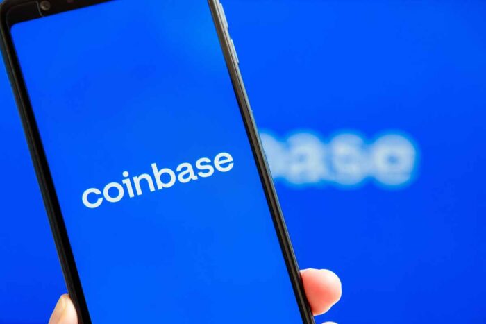 Coinbase mobile app running at smartphone screen with Coinbase logo at background - Coinbase class action, account hacks