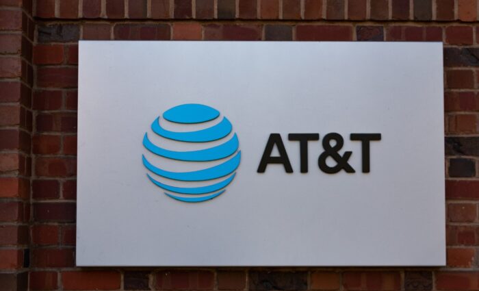 AT&T logo is displayed on the brick facade of telecommunication company office - at&t class action lawsuit, AT&T administrative fees, at&t administrative fee lawsuit