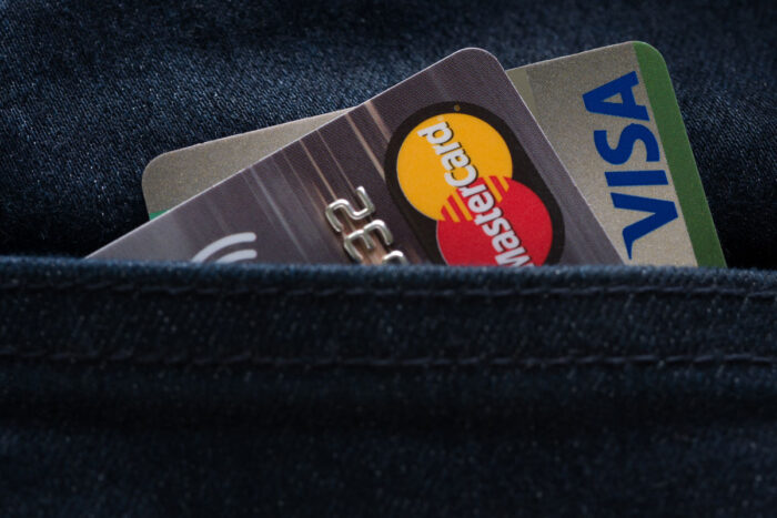 Mastercard and Visa credit cards in jeans pocket.