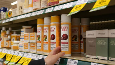 Close up of various Burt's Bees brand product on a grocery store shelf.