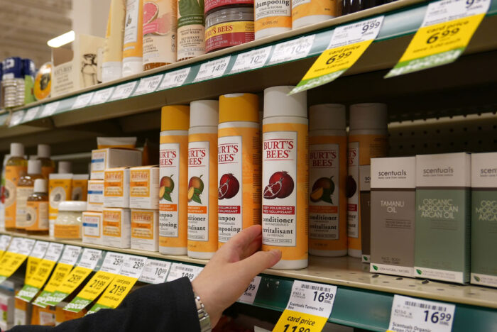 Close up of various Burt's Bees brand product on a grocery store shelf.