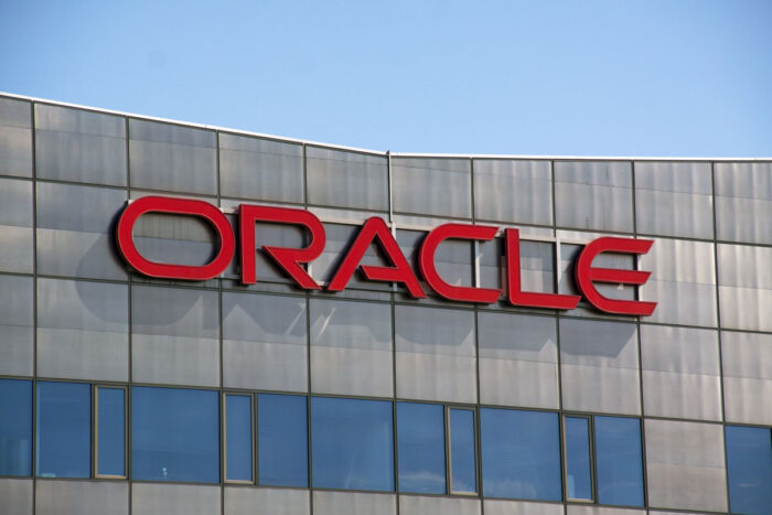 Close up of Oracle signage on exterior of a building against a blue sky - oracle corp. employees class action lawsuit