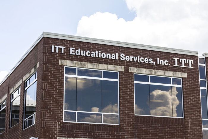 Exterior of an ITT Technical Institute building against a blue sky.