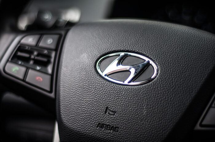 Close up of Hyundai emblem on a steering wheel.