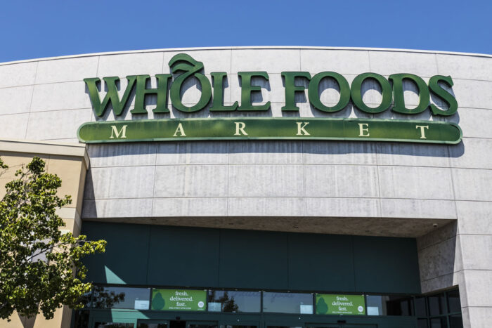 Exterior of a Whole Foods store against a blue sky - antibiotic-free beef
