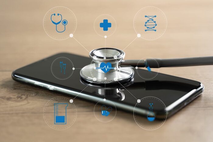 Close up of a stethoscope resting on a smartphone device. Medical data breach concept.