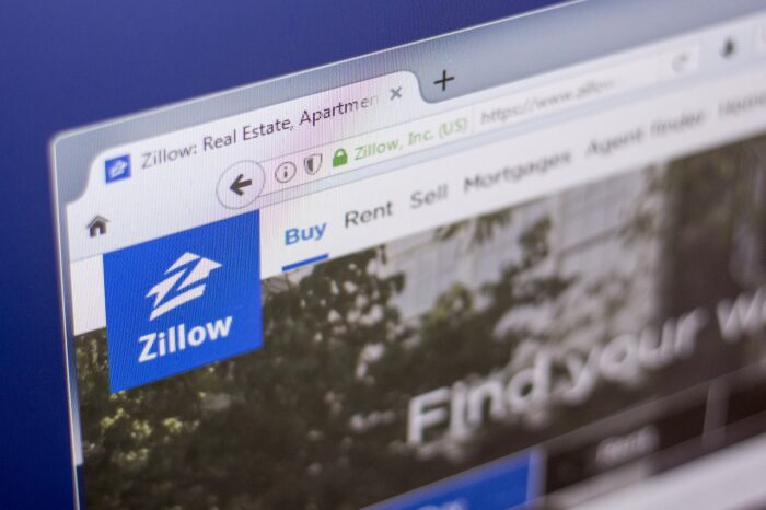 Homepage of Zillow - real estate service, on a display of PC, web adress - zillow.com