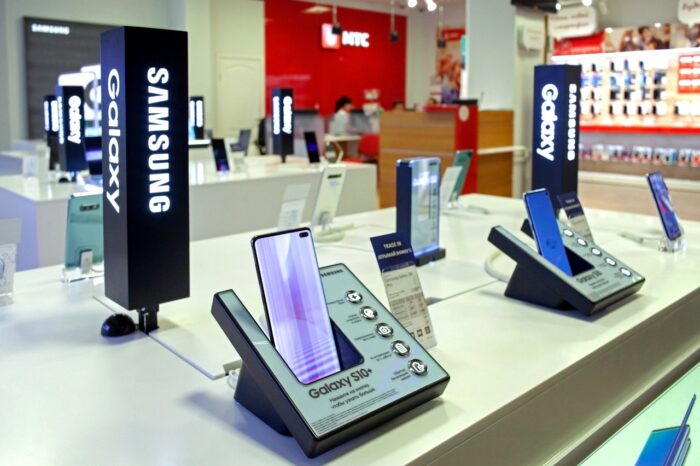 Samsung Galaxy S10+ mobile smartphone are displayed on retail display in electronic store.