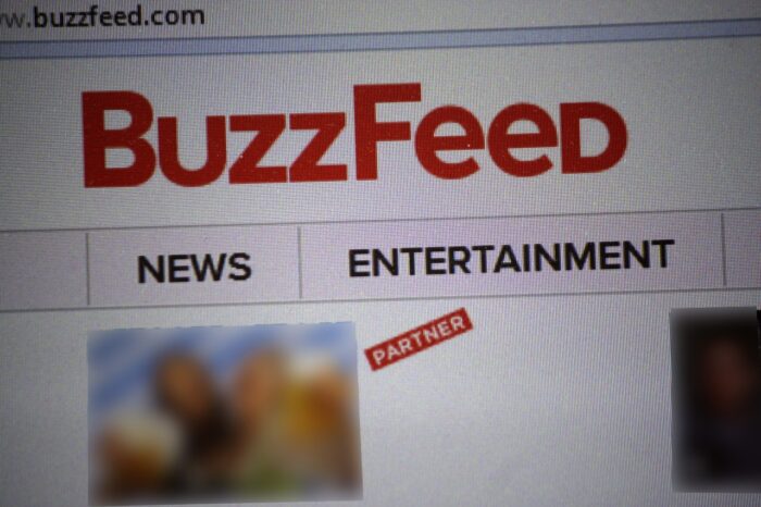 the logo of the brand "Buzzfeed" displayed on monitor